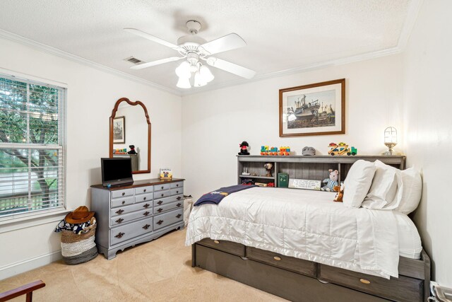 bedroom with ceiling fan, light colored carpet, a textured ceiling, and ornamental molding