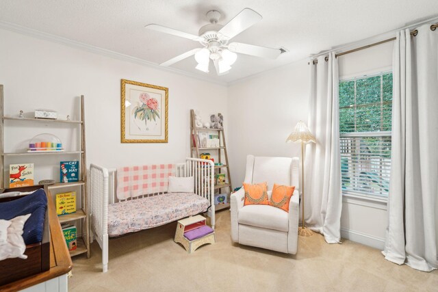 carpeted bedroom featuring crown molding and ceiling fan