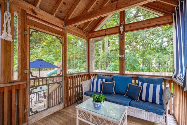 sunroom with wooden ceiling, vaulted ceiling with beams, and plenty of natural light