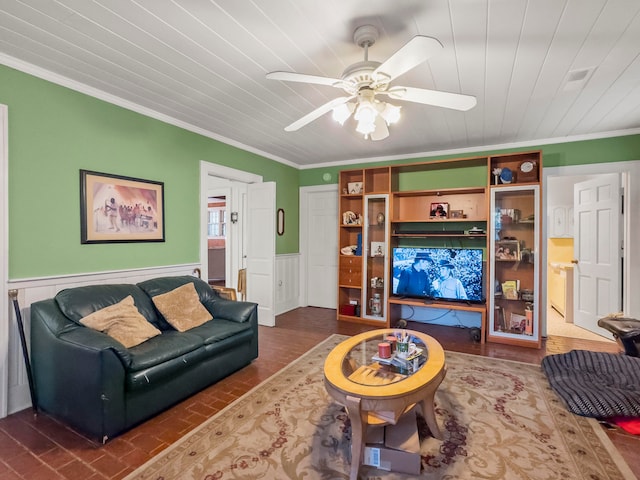 living room with ornamental molding and ceiling fan