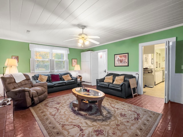 living room with ornamental molding and ceiling fan