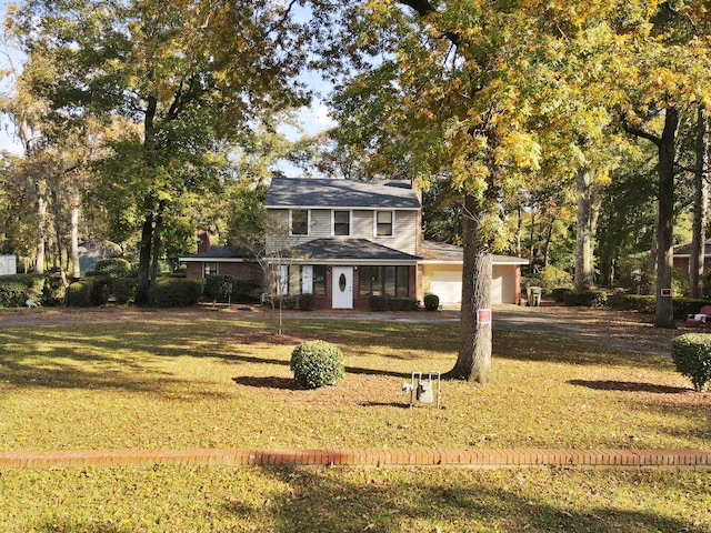 view of front of house with a garage and a front yard