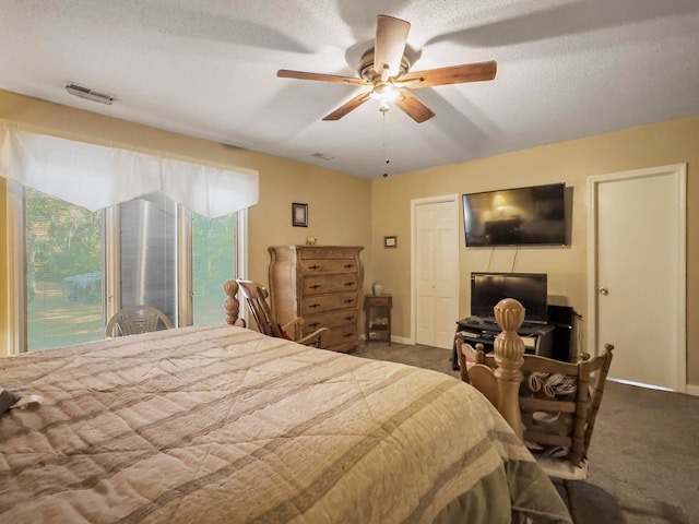 bedroom with ceiling fan, a textured ceiling, carpet flooring, and access to outside