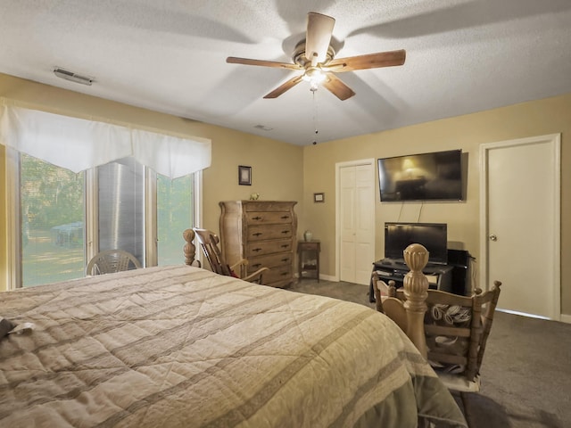 1104 2nd Ave, Kingstree, SC 29556 - bedroom featuring multiple windows, dark carpet, baseboards, and a textured ceiling