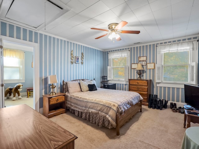 bedroom with ceiling fan, multiple windows, and light carpet