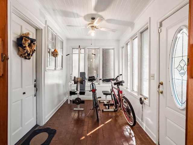 workout room featuring a wealth of natural light, ceiling fan, and crown molding