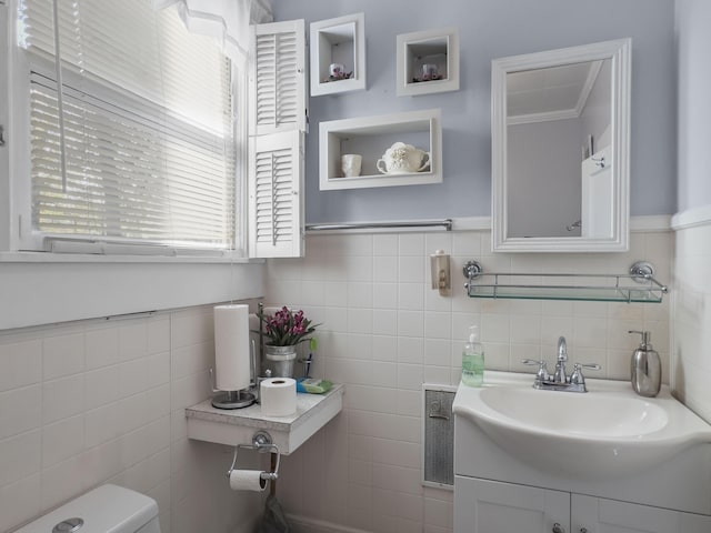 1104 2nd Ave, Kingstree, SC 29556 - bathroom featuring tile walls, vanity, toilet, and wainscoting