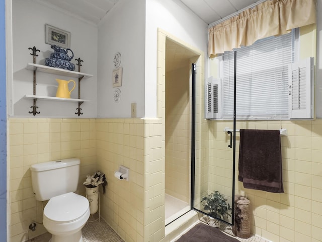 1104 2nd Ave, Kingstree, SC 29556 - bathroom featuring tile walls, a shower stall, toilet, ornamental molding, and a wainscoted wall