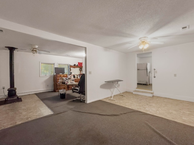 carpeted empty room with a textured ceiling and ceiling fan