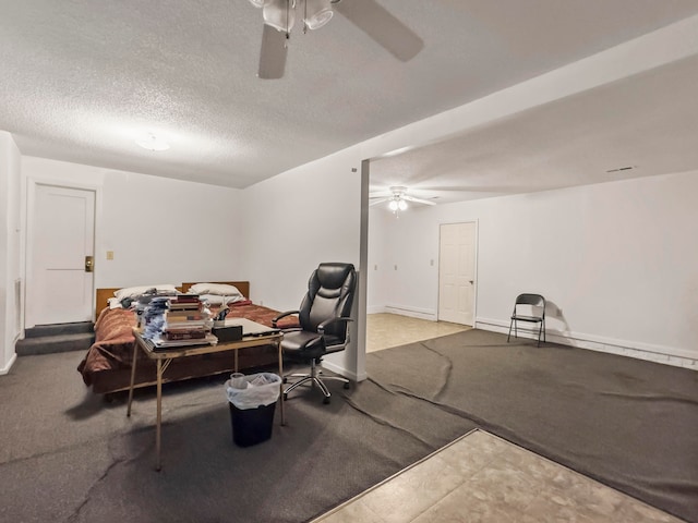 carpeted dining area featuring a textured ceiling and ceiling fan