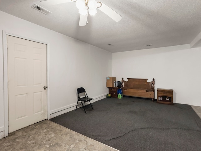 sitting room featuring a textured ceiling and ceiling fan