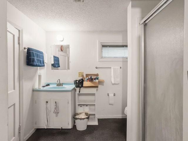 bathroom featuring toilet, an enclosed shower, vanity, and a textured ceiling