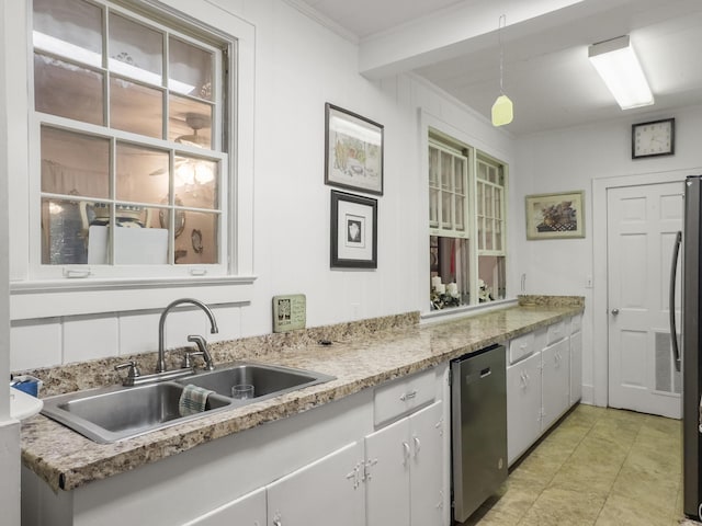 1104 2nd Ave, Kingstree, SC 29556 - kitchen with a sink, light countertops, stainless steel appliances, pendant lighting, and crown molding