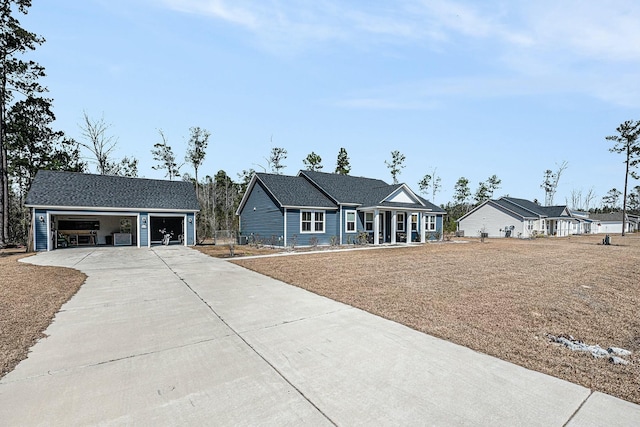 view of front of home with a garage, an outdoor structure, and a shingled roof