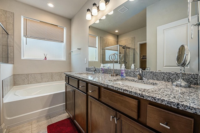 bathroom featuring a stall shower, visible vents, a sink, and a bath