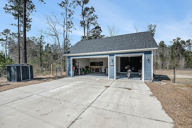 detached garage featuring fence