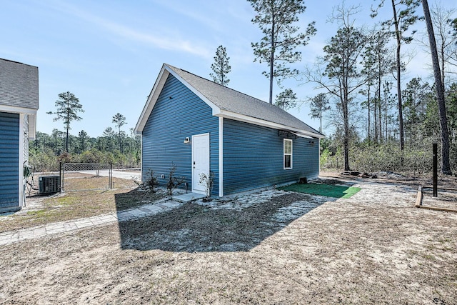 exterior space with central AC and fence