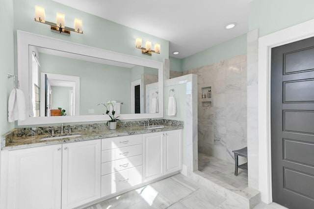bathroom with recessed lighting, double vanity, a sink, and a walk in shower