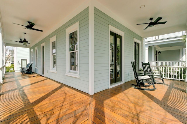 wooden deck with a porch and a ceiling fan