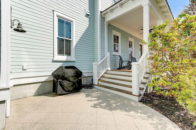 doorway to property with a porch and a patio