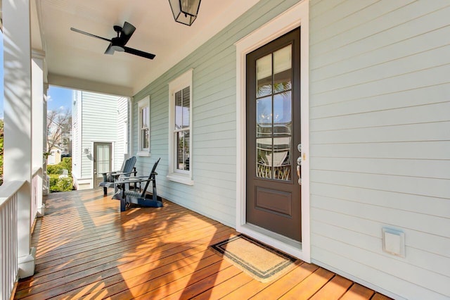 wooden deck with covered porch and ceiling fan