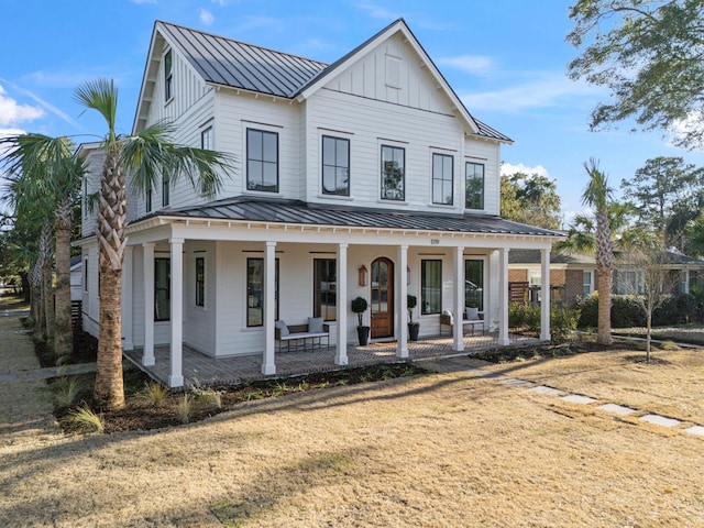 view of front facade with covered porch and a front lawn