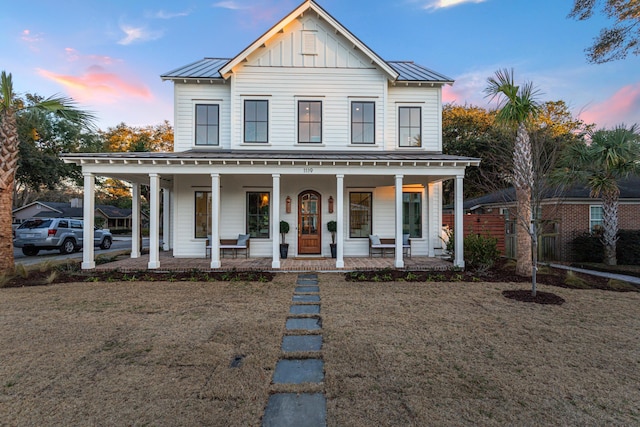 view of front of home with a yard and covered porch