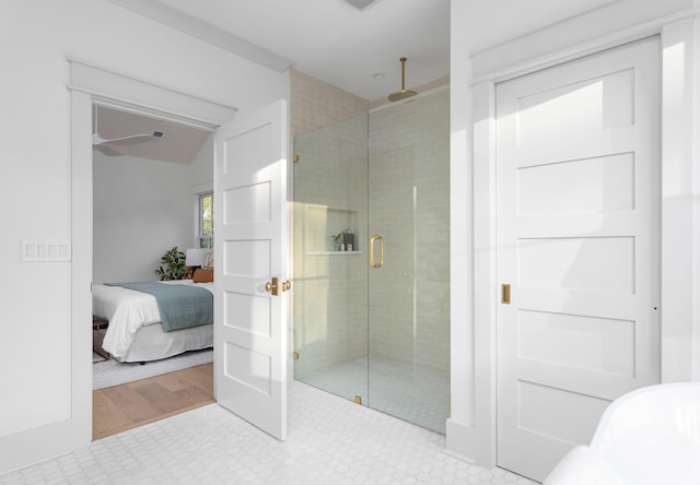 bathroom with a shower with door