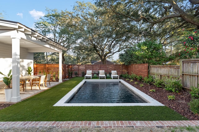 view of pool featuring a patio area and a lawn