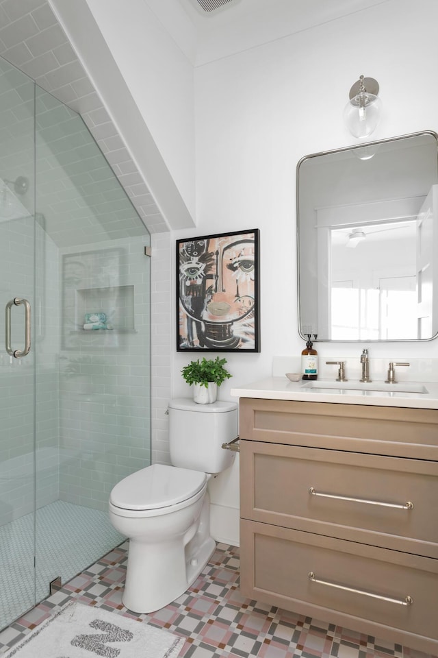 bathroom featuring vanity, toilet, and walk in shower