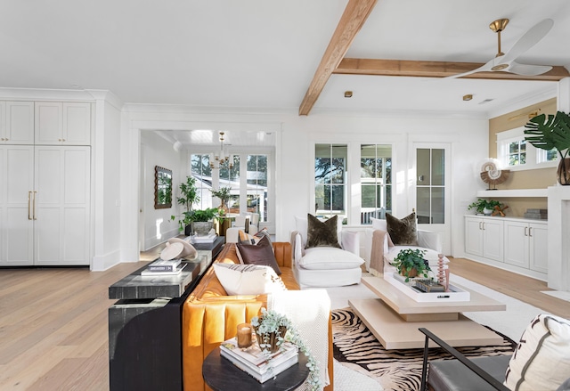 living room featuring crown molding, a wealth of natural light, beamed ceiling, and light wood-type flooring