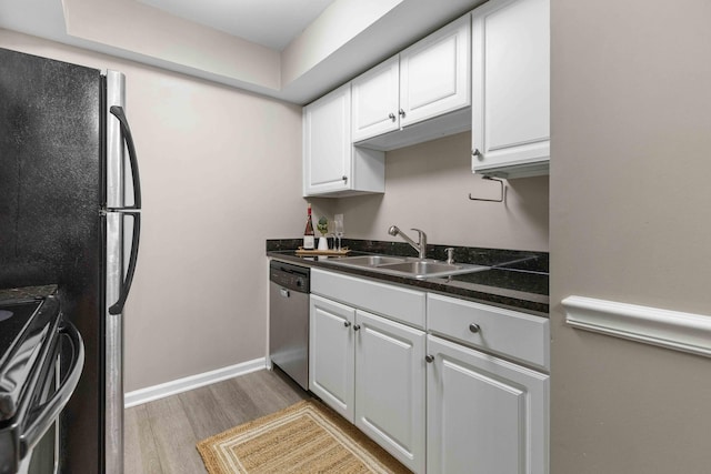 6240 Old Point Rd Unit C-8, Hanahan, SC 29410 - kitchen featuring stainless steel appliances, a sink, light wood-style flooring, dark countertops, and white cabinets