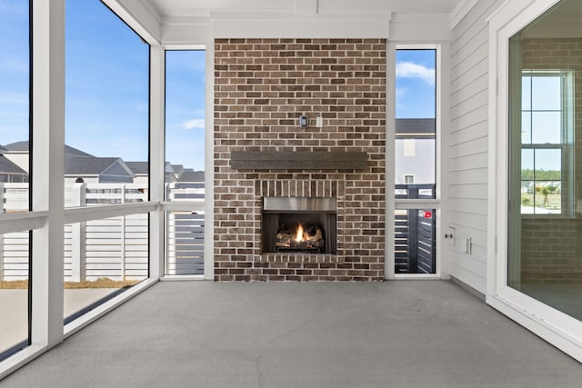 unfurnished living room with plenty of natural light, a fireplace, and carpet flooring