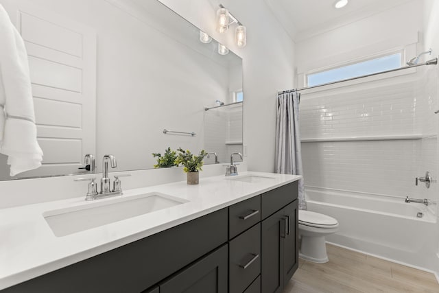 bathroom with toilet, double vanity, a sink, and shower / tub combo with curtain