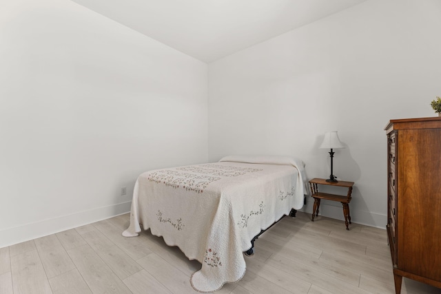 bedroom with baseboards and light wood-style floors