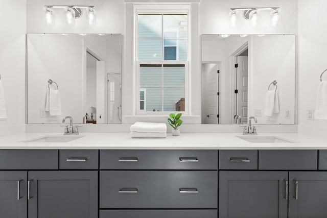 full bathroom with a sink and double vanity