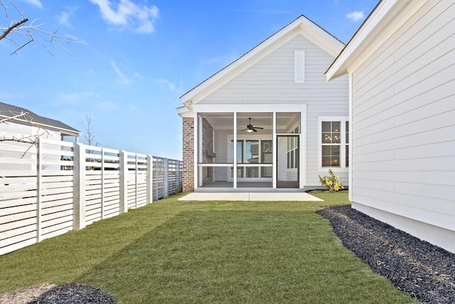 view of yard featuring a sunroom and a fenced backyard