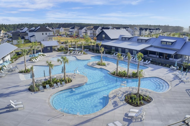 community pool featuring a patio and a residential view