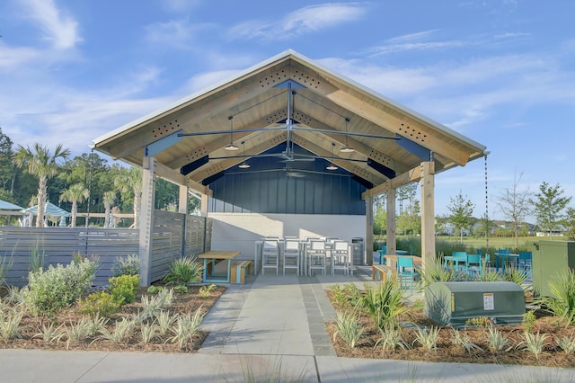 view of community with outdoor dry bar, a gazebo, a patio, and fence