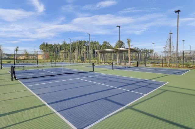 view of tennis court featuring fence