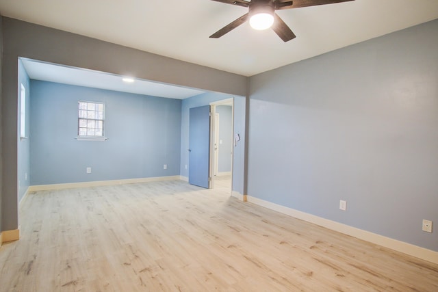 spare room featuring light hardwood / wood-style flooring and ceiling fan