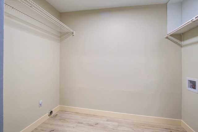 laundry room featuring hookup for a washing machine and light hardwood / wood-style floors