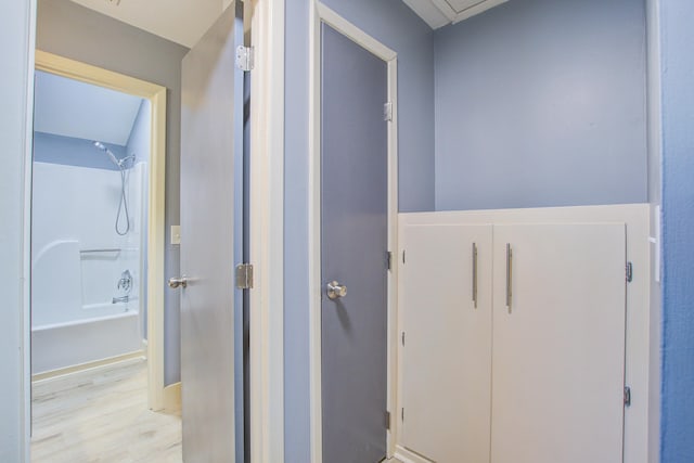 hallway with light hardwood / wood-style flooring