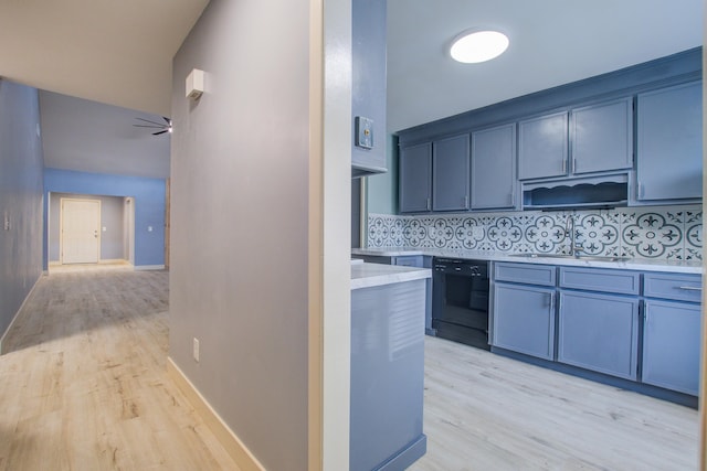 kitchen featuring tasteful backsplash, ceiling fan, black dishwasher, and light hardwood / wood-style floors