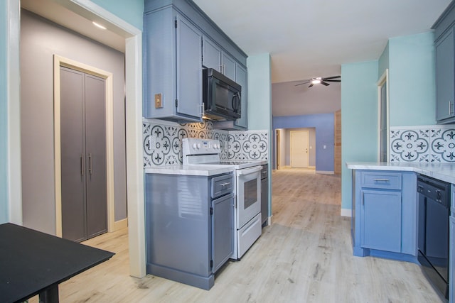 kitchen with blue cabinets, light hardwood / wood-style flooring, backsplash, and black appliances