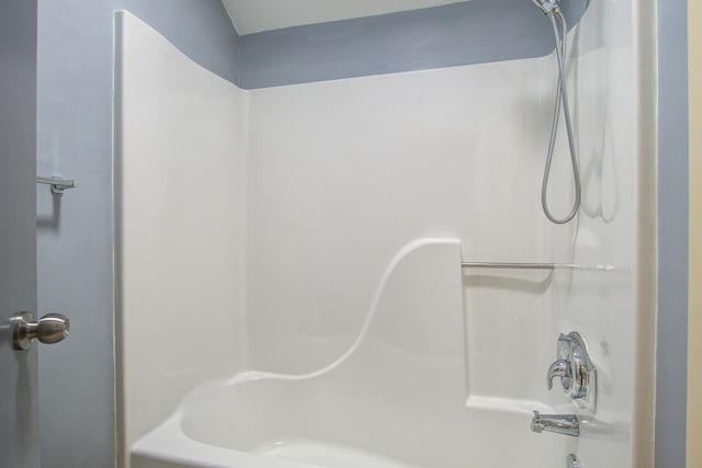 bathroom with bathing tub / shower combination