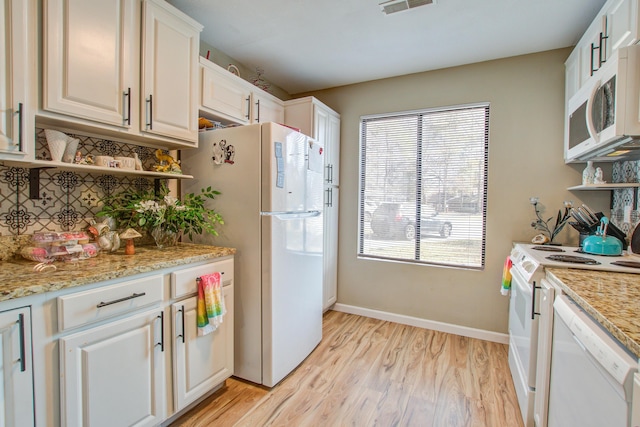 kitchen featuring light stone counters, white appliances, light hardwood / wood-style flooring, and white cabinets