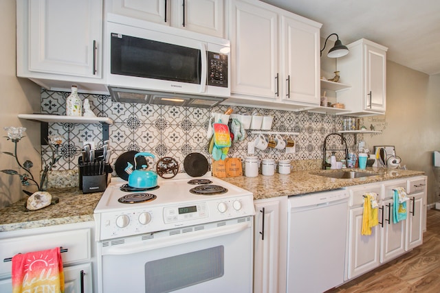 kitchen featuring white cabinetry, sink, white appliances, and tasteful backsplash