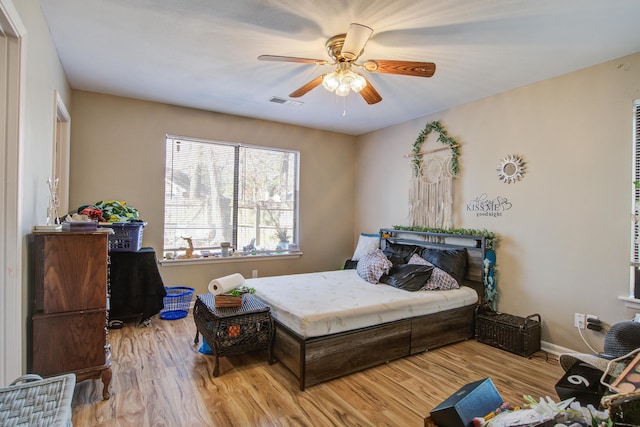 bedroom with ceiling fan and light hardwood / wood-style floors