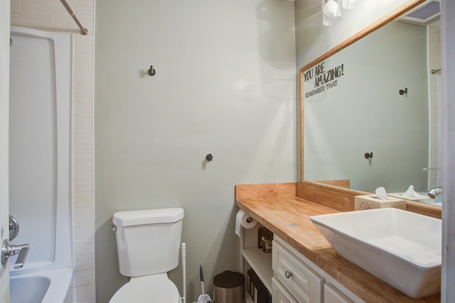 full bathroom featuring washtub / shower combination, vanity, and toilet